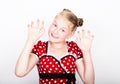 Beautiful young girl dressed in a red dress with white polka dots. Funny kids pamper and posing Royalty Free Stock Photo