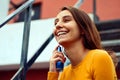 Beautiful young girl dressed in yellow, spraying perfume