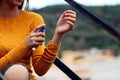 Beautiful young girl dressed in yellow, spraying perfume