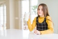 Beautiful young girl driking a glass of fresh milk with a confident expression on smart face thinking serious Royalty Free Stock Photo