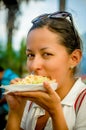 Beautiful young girl eating a tostada soft taco