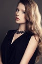 Beautiful young girl in elegant black dress with bijou