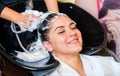 Beautiful young girl enjoying hair washing in hairdressing salon. Royalty Free Stock Photo