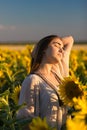 Beautiful young girl enjoying nature on the field of sunflowers Royalty Free Stock Photo