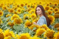 Beautiful young girl  enjoying nature  on the field of sunflowers at sunset. Copy space Royalty Free Stock Photo