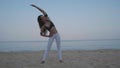 Beautiful girl exercising on the sandy beach Royalty Free Stock Photo