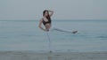 Beautiful girl exercising on the sandy beach Royalty Free Stock Photo