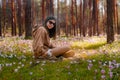 pretty young girl or teenager on the beach domesticating a squirrel