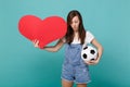 Beautiful young girl football fan cheer up support favorite team with soccer ball, empty blank red heart isolated on Royalty Free Stock Photo