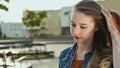 Beautiful young girl goes and straightens hair