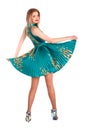 Beautiful young girl in a green dress dancing. Royalty Free Stock Photo