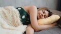Beautiful young girl in a green nightie sleeps on a yellow pillow Royalty Free Stock Photo