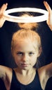 Beautiful young girl gymnast holding aloft a glowing circle Royalty Free Stock Photo