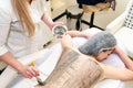 Beautiful young girl having seaweed cosmetic mask and body massage with scrub in spa salon Royalty Free Stock Photo