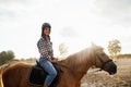 Beautiful young girl with her horse at sunset