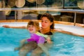 Beautiful young girl and her mom having fun in a jacuzzi Royalty Free Stock Photo