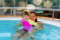 Beautiful young girl and her mom having fun in a jacuzzi Royalty Free Stock Photo