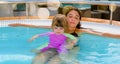 Beautiful young girl and her mom having fun in a jacuzzi Royalty Free Stock Photo