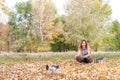 Beautiful young girl with her Yorkshire terrier dog puppy enjoying and playing in the autumn day in the park selective focus Royalty Free Stock Photo