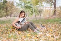 Beautiful young girl with her Yorkshire terrier dog puppy enjoying and playing in the autumn day in the park selective focus Royalty Free Stock Photo