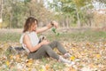 Beautiful young girl with her Yorkshire terrier dog puppy enjoying and playing in the autumn day in the park selective focus Royalty Free Stock Photo