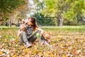 Beautiful young girl with her Yorkshire terrier dog puppy enjoying and playing in the autumn day in the park selective focus Royalty Free Stock Photo