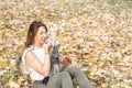 Beautiful young girl with her Yorkshire terrier dog puppy enjoying and playing in the autumn day in the park selective focus Royalty Free Stock Photo