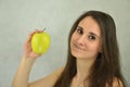 Beautiful young girl is holding an apple Royalty Free Stock Photo