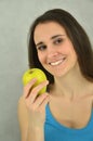 Beautiful young girl is holding an apple Royalty Free Stock Photo