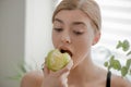 Beautiful young girl holding an apple in her hands. Vegetables and fruits Royalty Free Stock Photo