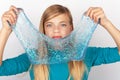 Beautiful young girl holding a glitter slime in front of her face Royalty Free Stock Photo