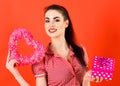 Beautiful young girl holding a heart shape gift box Royalty Free Stock Photo