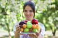 Beautiful young girl holding a plate with fruits. Selective focus on plate. Royalty Free Stock Photo