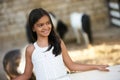 Beautiful young girl and horses in stall Royalty Free Stock Photo