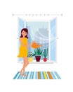 Young girl, housewife, doing household chores, watering home plant flowers. Royalty Free Stock Photo