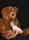 Beautiful young girl with huge bear