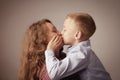 Beautiful young girl hugging her younger brother. Boy kisses his sister. Family, love and tenderness concept Royalty Free Stock Photo