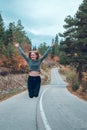 Beautiful young girl jumping for joy on the road in Svaneti Royalty Free Stock Photo