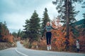 Beautiful young girl jumping for joy on the road in Svaneti Royalty Free Stock Photo