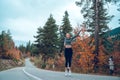 Beautiful young girl jumping for joy on the road in Svaneti Royalty Free Stock Photo