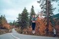 Beautiful young girl jumping for joy on the road in Svaneti Royalty Free Stock Photo