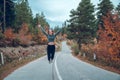 Beautiful young girl jumping for joy on the road in Svaneti Royalty Free Stock Photo