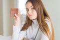 Beautiful young girl kid eating chocolate bar with a confident expression on smart face thinking serious