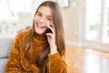 Beautiful young girl kid having a conversation talking on smartphone with a happy face standing and smiling with a confident smile Royalty Free Stock Photo