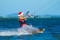 Beautiful young girl on the kite in the costume of Santa Claus. Royalty Free Stock Photo