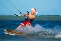 Beautiful young girl on the kite in the costume of Santa Claus. Royalty Free Stock Photo