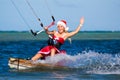 Beautiful young girl on the kite in the costume of Santa Claus. Royalty Free Stock Photo