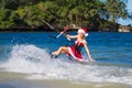 Beautiful young girl on the kite in the costume of Santa Claus. Royalty Free Stock Photo