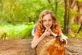 Beautiful young girl laying on the log in forest Royalty Free Stock Photo