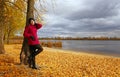 Beautiful young girl leaning against tree Royalty Free Stock Photo